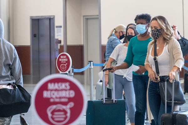 09/04/2020 -Atlanta, Georgia - Delta Air Lines customers wear masks as they wait to be served at the ticker counter in the domestic terminal at Hartsfield-Jackson Atlanta International Airport, Friday, September 4, 2020. (Alyssa Pointer / Alyssa.Pointer@ajc.com)