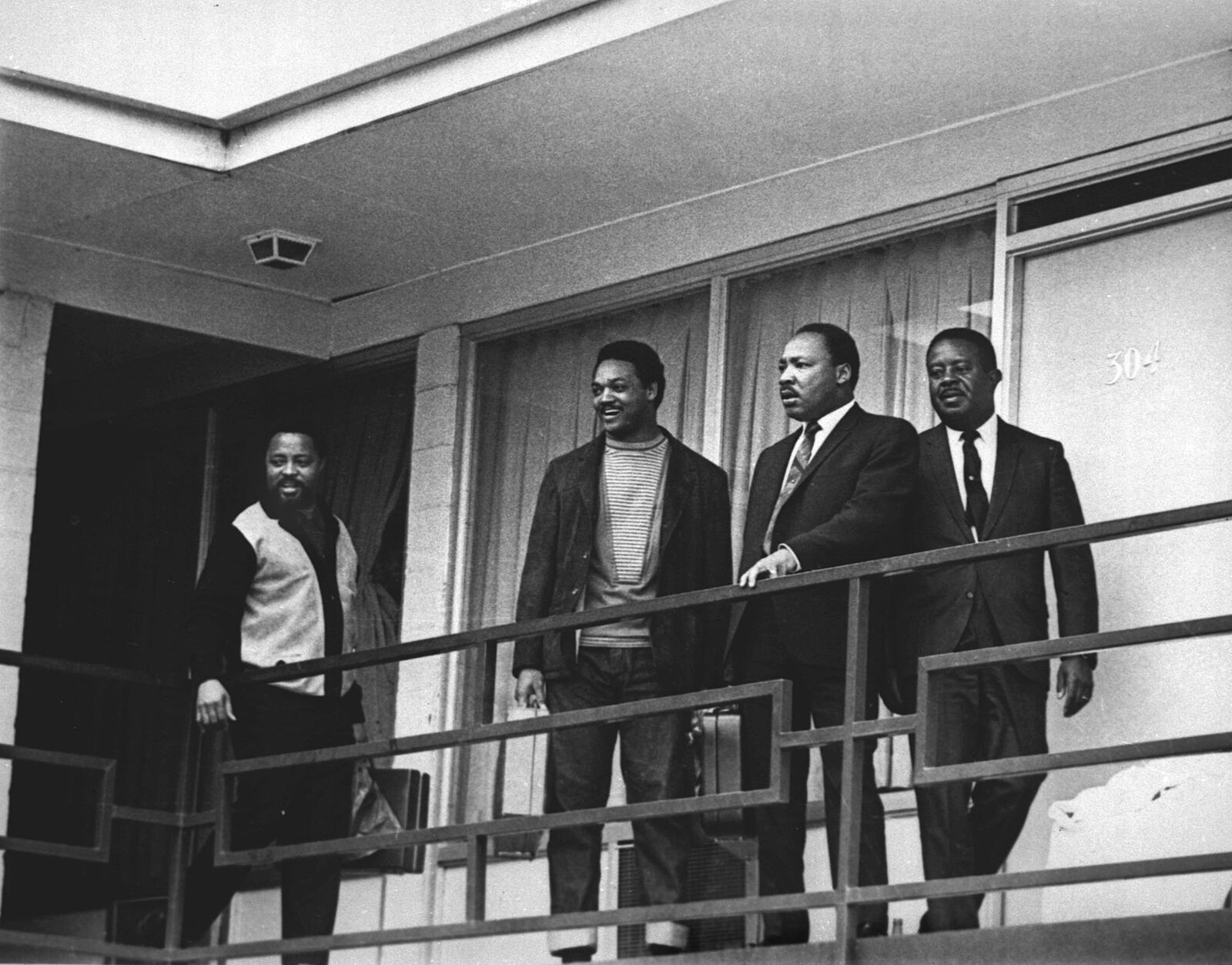 FILE - In this April 3, 1968 file photo, the Rev. Martin Luther King Jr. stands with other civil rights leaders on the balcony of the Lorraine Motel in Memphis, Tenn., a day before he was assassinated at approximately the same place. From left are Hosea Williams, Jesse Jackson, King, and Ralph Abernathy. King is one of America’s most famous victims of gun violence. Just as guns were a complicated issue for King in his lifetime, they loom large over the 30th anniversary of the holiday honoring his birthday. (AP Photo/Charles Kelly, File)