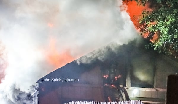 Neighbor Tony Gordon said he saw flames shooting 8 to 10 feet above the roof, and the fence and grass on the left side of the home were also on fire. 