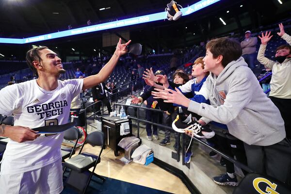 012322 Atlanta: Georgia Tech guard Michael Devoe autographs and tosses his shoes to young fans following a 103-53 victory over Clayton State in a NCAA college basketball game on Sunday, Jan. 23, 2022, in Atlanta.   “Curtis Compton / Curtis.Compton@ajc.com”`