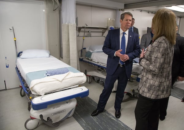 Georgia Governor Brian Kemp talks to Grady's Michelle Wallace inside the mobile ER unit. (Photo by Phil Skinner)