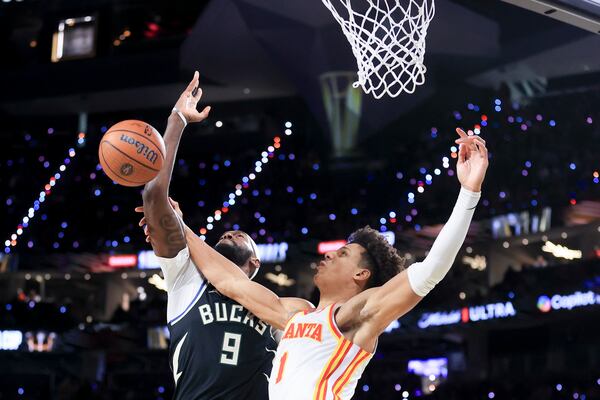 Milwaukee Bucks forward Bobby Portis (9) and Atlanta Hawks forward Jalen Johnson (1) vie for the ball during the second half of a semifinal game in the NBA Cup basketball tournament Saturday, Dec. 14, 2024, in Las Vegas. (AP Photo/Ian Maule)