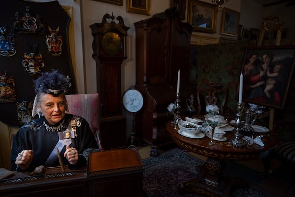 Sandra Nieland dressed as Queen Victoria is photographed as people in costumes from Charles Dickens' 19th-century English era take part in a Dickens Festival, in Deventer, Netherlands, Saturday, Dec. 14, 2024. (AP Photo/Peter Dejong)