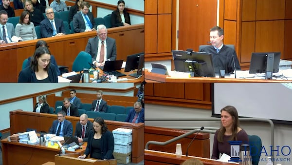 In this image from a video provided by Idaho Fourth District Court, Rebecca Vincen-Brown, lower right, tears up as she testifies in court about her abortion, Nov. 12, 2024, in Boise, Idaho. (Idaho Fourth District Court via AP)