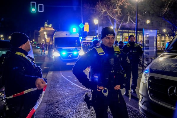 Police officers attend the scene at the Holocaust memorial after a man was attacked at the memorial site in Berlin, Germany, Friday, Feb. 21, 2025. (AP Photo/Ebrahim Noroozi)