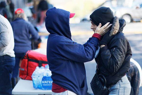 Tracy Thompson, who leads the nonprofit Elizabeth Foundation, helps provide comfort and put on a winter hat for a person named Mikayla on Sunday, November 13, 2022. Since 2018 the Elizabeth Foundation has provided services and supplies to homeless people, particularly near an encampment known at The Hill in Buckhead.
Miguel Martinez / miguel.martinezjimenez@ajc.com