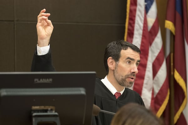 03/05/2018 — Atlanta, GA - Fulton County Chief Judge Robert McBurney raises his hand to repeat an oath for the possible jury to repeat during the first day of jury selection for the Tex McIver case in a Fulton County courtroom on Monday, March 5, 2018. ALYSSA POINTER/ALYSSA.POINTER@AJC.COM