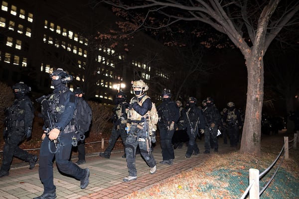 South Korean martial law soldiers leave the National Assembly in Seoul, South Korea, Wednesday, Dec. 4, 2024. (Kim Ju-sung/Yonhap via AP)