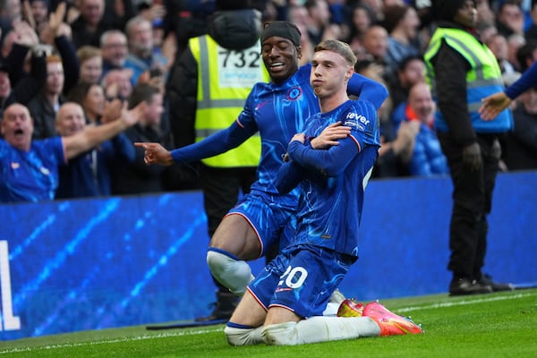 Chelsea's Cole Palmer, right, celebrates after scoring his side's third goal during the English Premier League soccer match between Chelsea and Aston Villa at the Stamford Bridge stadium in London, Sunday, Dec. 1, 2024. (AP Photo/Kirsty Wigglesworth)