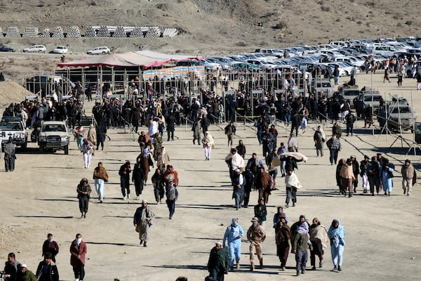 People attend the funeral prayer of Khalil Haqqani, the minister for refugees and repatriation, during his funeral procession in eastern Paktia province, Afghanistan, Thursday, Dec. 12, 2024. (AP Photo/Saifullah Zahir)