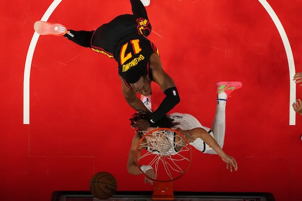 Denver Nuggets guard Julian Strawther (3) and Atlanta Hawks forward Onyeka Okongwu (17) fight for a rebound during the first half of an NBA basketball game Sunday, Dec. 8, 2024, in Atlanta. (AP Photo/John Bazemore)