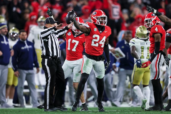 Georgia defensive back Malaki Starks (24) reacts after recovering a fumble during the fourth quarter against Georgia Tech at Sanford Stadium on Nov. 29 in Athens, Ga. The ball was ruled an incomplete pass. Georgia beat Georgia Tech 44-42 in eight overtimes.  (Jason Getz/AJC)
