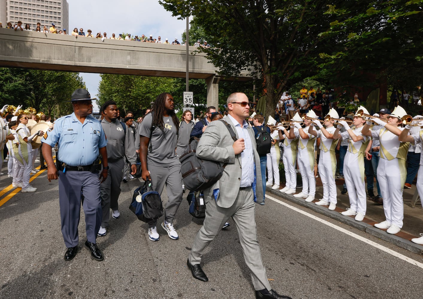 Georgia Tech head coach Brent Key leads his team down North Avenue to the stadium.  DJ Envy held the first pregame concert at Georgia Tech’s new "Helluva Block Party".  North Avenue was closed before the football game vs South Carolina State for the event in Atlanta on Saturday, September 9, 2023.   (Bob Andres for the Atlanta Journal Constitution)