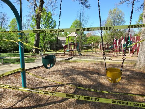 The tennis courts, ball field and dog park are now closed at Lewis Park in Marietta, where a newly posted sign notes new hours and social distancing guidelines. Unlike Marietta, Cobb County has closed all of its parks, including open spaces and buildings, due to the coronavirus pandemic. Photos: Jennifer Brett, jbrett@ajc.com