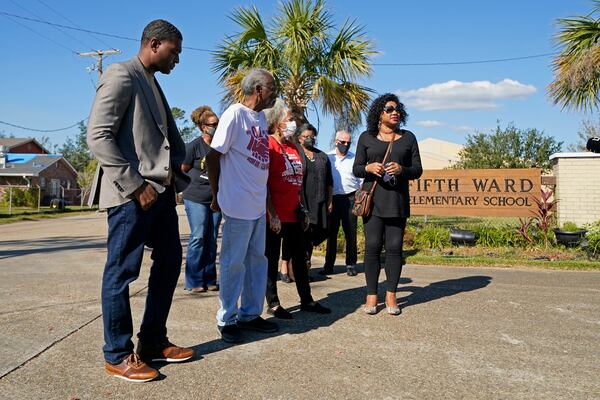 FILE - EPA Administrator Michael Regan, left, arrives at the Fifth Ward Elementary School, which is near the Denka plant, with Robert Taylor, second left, founder of Concerned Citizens of St. John's Parish, and Lydia Gerard, third left, a member of the group, in Reserve, La., Nov. 16, 2021. (AP Photo/Gerald Herbert, File)