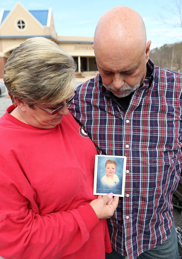 Local residents Bud and Delisa Hill, who followed the family on Facebook, hold a program after attending family visitation during the Tripp Halstead Memorial at the Jefferson Civic Center on Sunday, March 18, 2018, in Jefferson. The 7-year-old died Thursday following a traumatic brain injury five years ago from a falling tree limb. Curtis Compton/ccompton@ajc.com