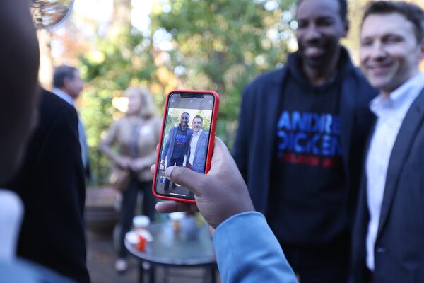 After speaking to the crowd, mayoral candidate Andre Dickens took photos with supporters in Ansley Park. Miguel Martinez for The Atlanta Journal-Constitution 