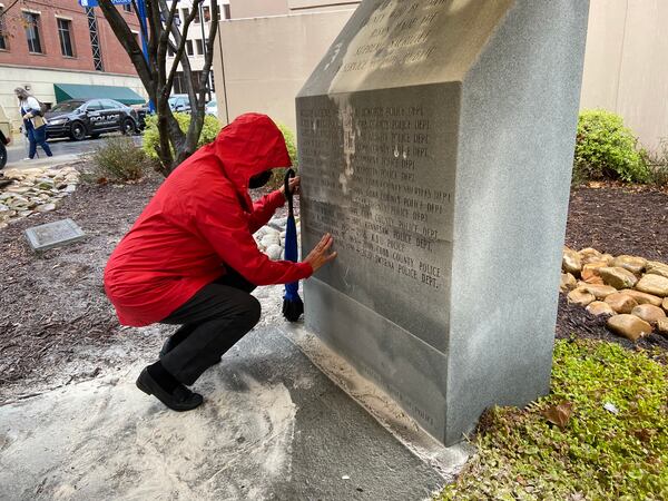 Noli Ewing touches her son's name Thursday after it was added to a granite marker commemorating Cobb County law enforcement officers killed in the line of duty. Smyrna police Officer Christopher Ewing was 34 when he was killed last year by a suspected drunk driver.