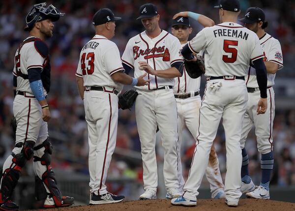 Braves pitcher Drew Smyly (center) hands the ball to manager Brian Snitker (43) in the sixth inning of the second game of a doubleheader against the St. Louis Cardinals, Sunday, June 20, 2021, at Truist Park in Atlanta. (Ben Margot/AP)