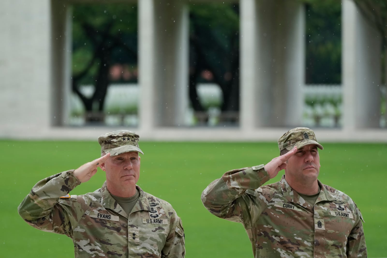 U.S. Maj. Gen. Marcus Evans, left, commanding general of the U.S. Army's 25th Infantry Division and Sgt. Major Shaun Curry salute during a wreath laying ceremony to honor American soldiers died during World War II at the Manila American Cemetery and Memorial in Taguig, Philippines Monday, Oct. 21, 2024. (AP Photo/Aaron Favila)