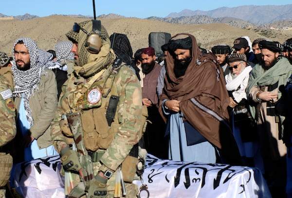 Acting interior minister Sirajuddin Haqqani, center, and mourners offer funeral prayers near the dead body of Khalil Haqqani, the minister for refugees and repatriation, during his funeral procession in eastern Paktia province, Afghanistan, Thursday, Dec. 12, 2024.(AP Photo/Saifullah Zahir)