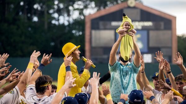 The Savannah Bananas honor Banana Baby Finn Ervin as his father Chris Ervin holds him up during a pregame ceremony during a home game. (AJC Photo/Stephen B. Morton)