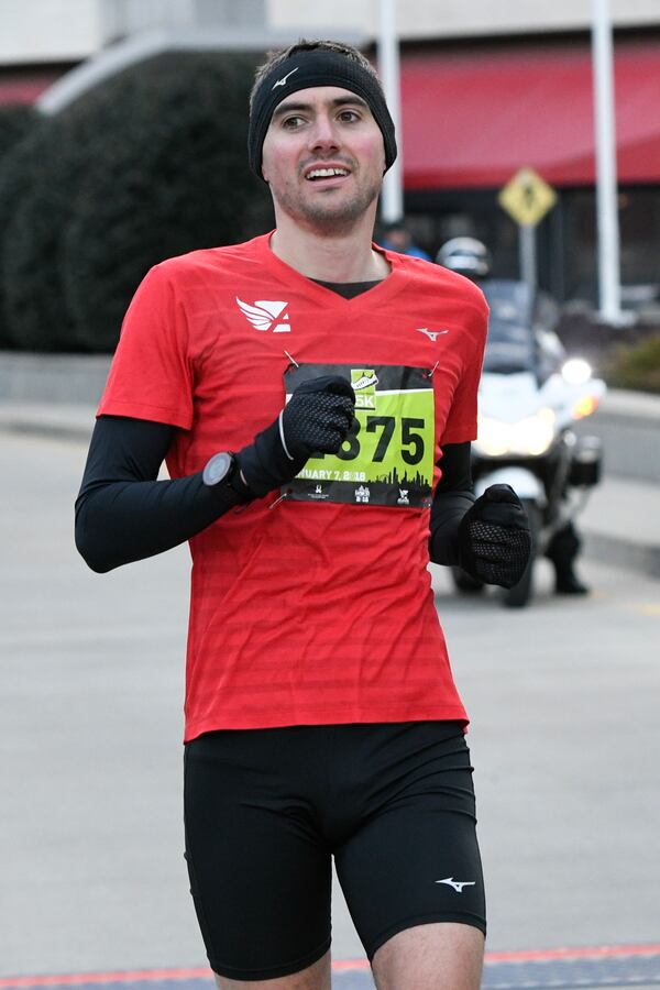 U.K. runner Rob Mullett, a 2016 Olympian, wins the Extra Yard 5K on Sunday Jan. 7, 2018, in Atlanta. As the men’s winner, he also won one of the three sets of tickets awarded to Monday’s college football national championship game at Mercedes-Benz Stadium.