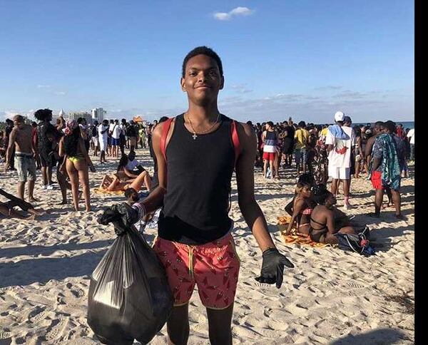 University of West Georgia student Joseph Caraway holds a bag of trash he picked up from people littering on Miami Beach. Caraway voluntarily picked up the trash during a Spring Break visit to the beach. Local officials lauded Caraway, 19, for his efforts. PHOTO CONTRIBUTED.