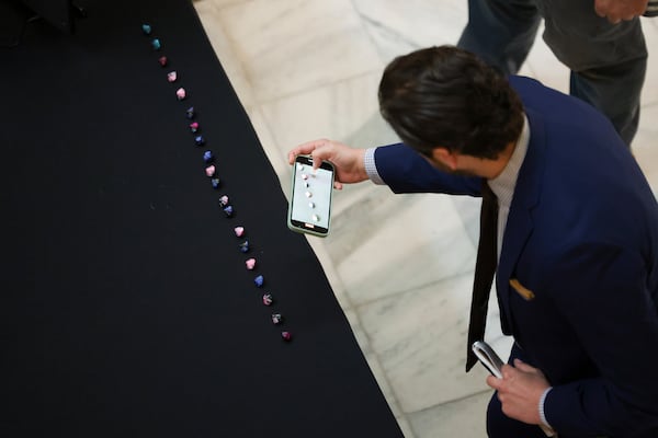 A man records the final selection of dice that the Secretary of State’s office used to randomly select batches of ballots to audit in the presidential election at the Georgia State Capitol, Thursday, November 14, 2024, in Atlanta. (Jason Getz / AJC)