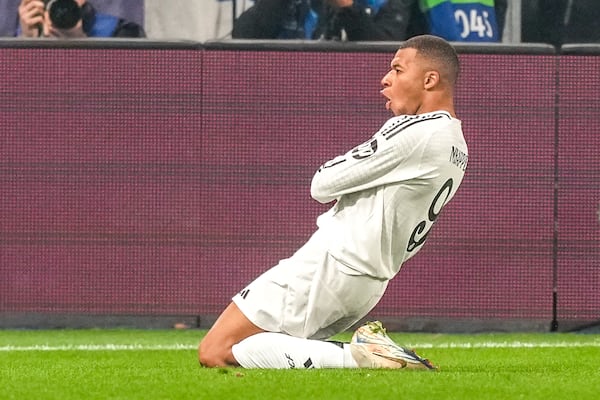 Real Madrid's Kylian Mbappe celebrates after he scored his side's first goal during the Champions League opening phase soccer match between Atalanta and Real Madrid at the Bergamo's stadium, in Bergamo, Italy, Tuesday, Dec. 10, 2024. (AP Photo/Antonio Calanni)