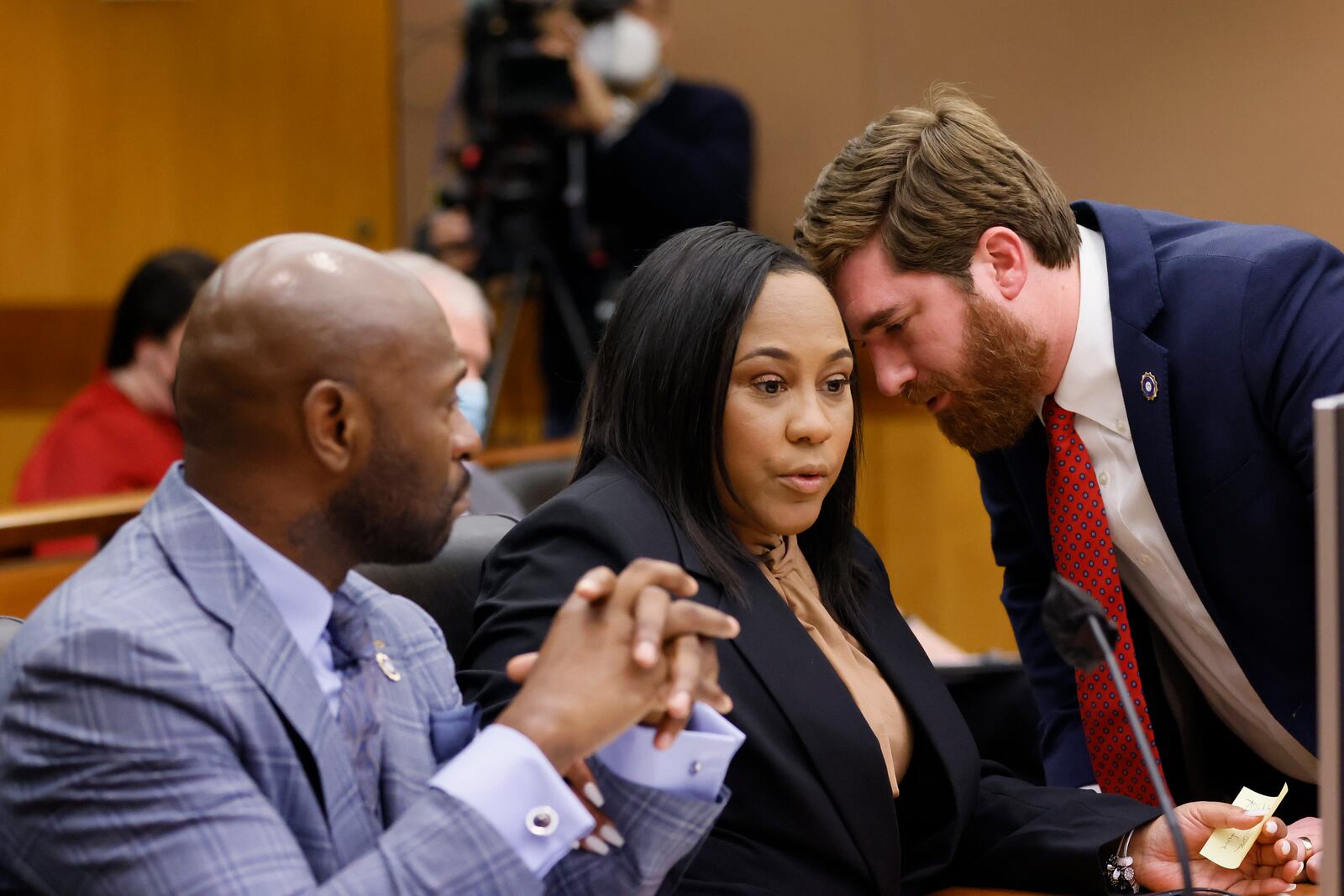 Fulton County D.A. Fani Willis (center) confers with colleagues Nathan Wade (left) and Donald Wakeford (right) during a Jan. 24, 2023, hearing before Fulton Superior Court Judge Robert McBurney. Miguel Martinez / miguel.martinezjimenez@ajc.com