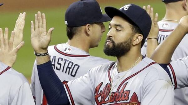 Matt Kemp celebrates with teammates after Braves' sixth straight win Thursday at Miami. He hit two homers in the game. (AP photo)