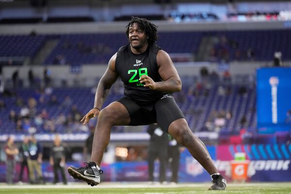 Missouri offensive lineman Armand Membou runs a drill at the NFL football scouting combine in Indianapolis, Sunday, March 2, 2025. (AP Photo/George Walker IV)