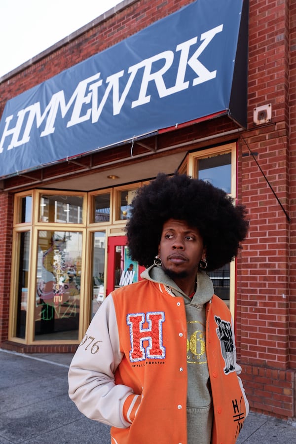 Atlanta rapper Trinidad James poses for a photo in front of his new boutique Hommewrk located inside Underground Atlanta on March 7. (Natrice Miller/AJC)