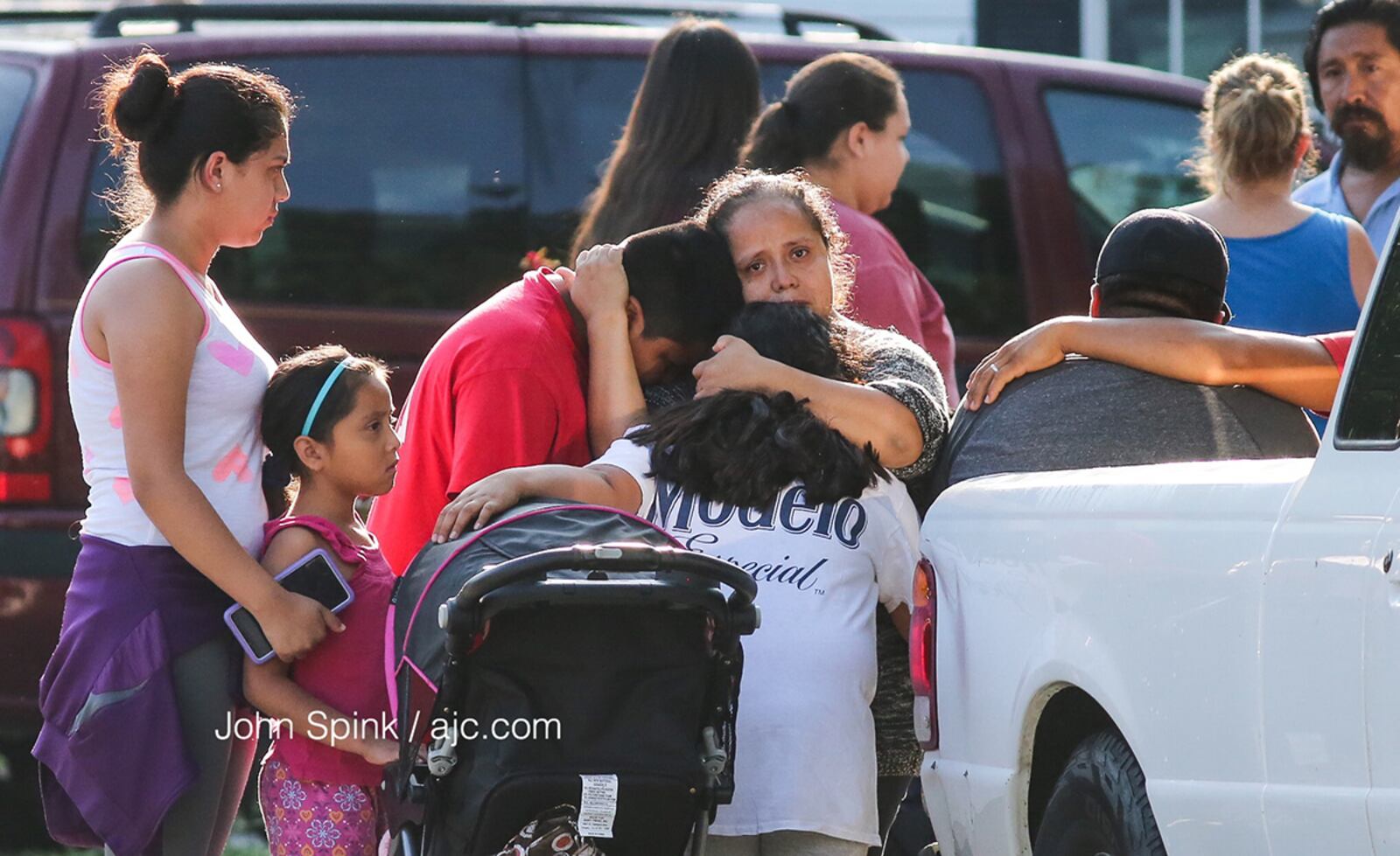 Friends and neighbors grieve over the stabbing deaths of four children and their father in their Loganville home on July 6, 2017. (John Spink / jspink@ajc.com)