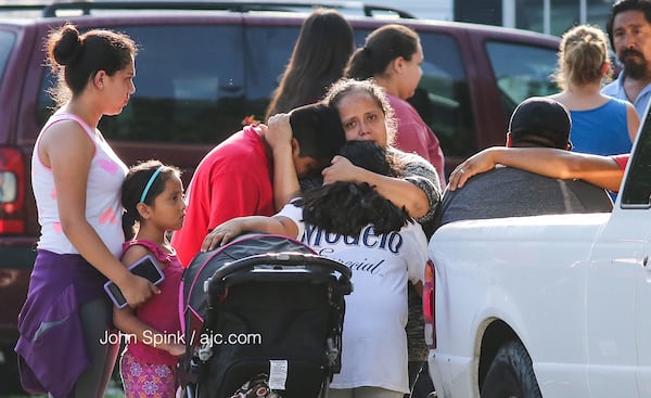 Friends and neighbors grieve over the stabbing deaths of four children and their father in their Loganville home on July 6, 2017. (John Spink / jspink@ajc.com)