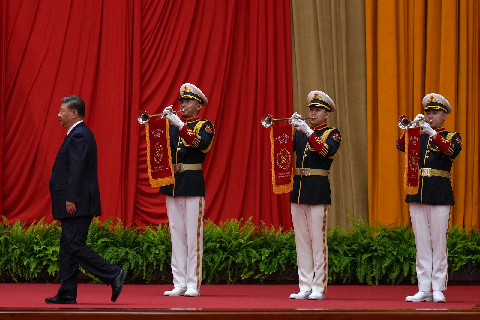 Chinese President Xi Jinping walks past a music band as he is on his way to deliver his speech at a dinner marking the 75th anniversary of the founding of the People's Republic of China, at the Great Hall of the People in Beijing, Monday, Sept. 30, 2024. (AP Photo/Andy Wong)