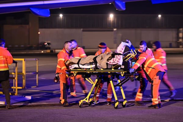 A patient is carried on a strecher by medical staff as survivors of the Kocani night club fire, treated with burn injuries, are transported to hospital upon arrival by a Hungarian Air Force MH Airbus A319 jet at the capital city's international airport in Budapest, Hungary, early Wednesday, March 19, 2025. (Peter Lakatos/MTI via AP)