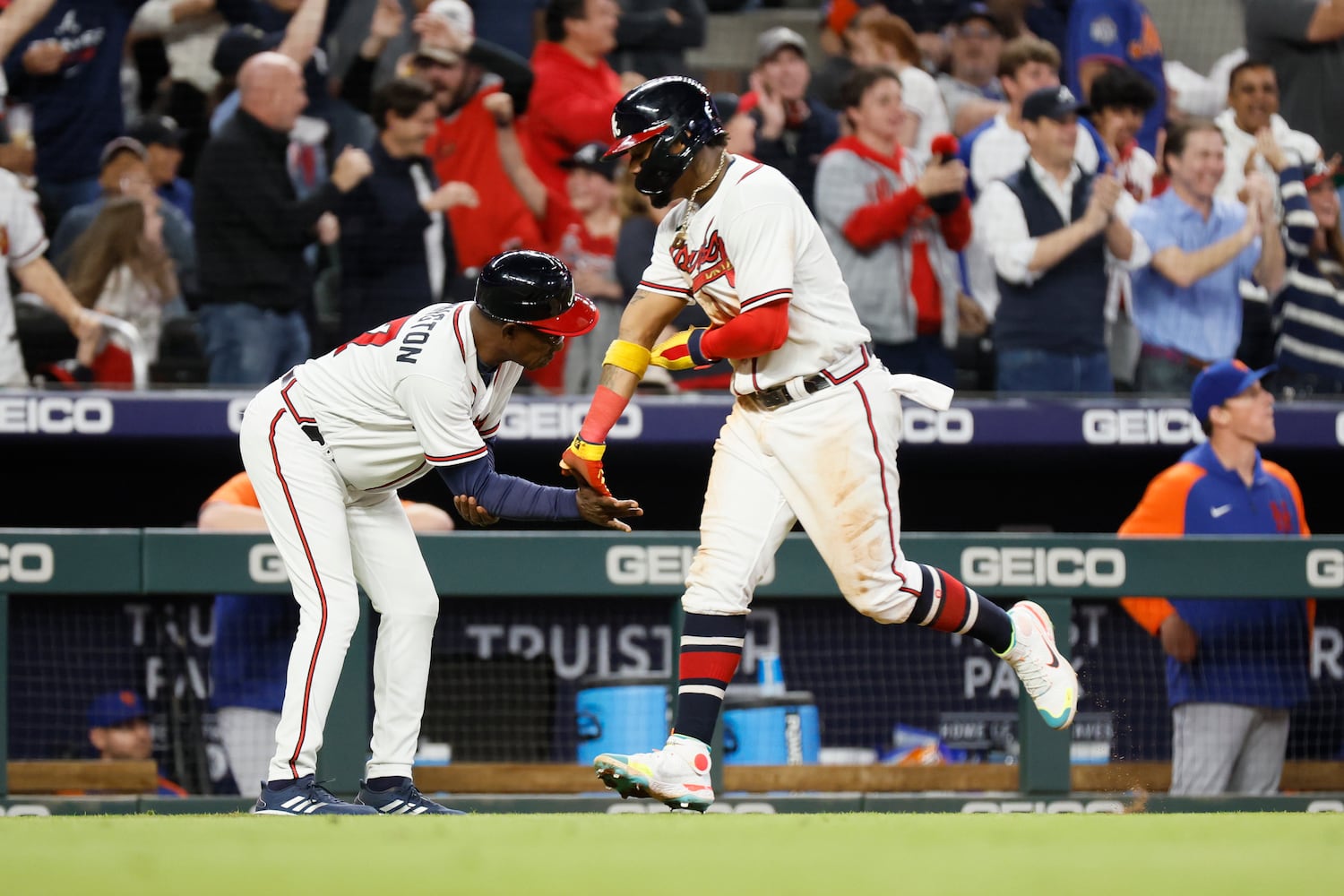 Braves right fielder Ronald Acuna Jr. (13) shakes hands with Brave's third base coach Ron Washington as he approaches home plate during the fourth inning of a baseball game against the New York Mets at Truist Park on Saturday, Oct. 1, 2022. Miguel Martinez / miguel.martinezjimenez@ajc.com