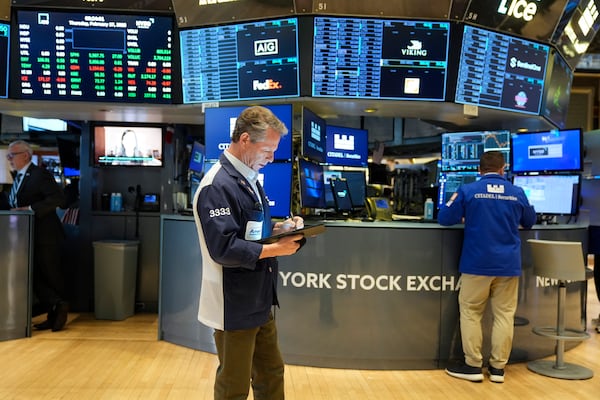 People work on the floor at the New York Stock Exchange in New York, Thursday, Feb. 27, 2025. (AP Photo/Seth Wenig)