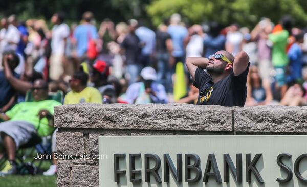 Jose Garcia watches the solar eclipse at Fernbank Science Center on Monday. JOHN SPINK / JSPINK@AJC.COM