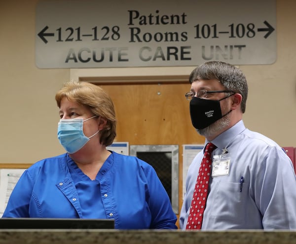 Hospital CEO Kerry Trapnell confers with chief clinical officer Tammy Harlow in the acute care unit of Elbert Memorial Hospital in Elberton, which is running out of rooms for patients from the recent surge. (Curtis Compton / ccompton@ajc.com)