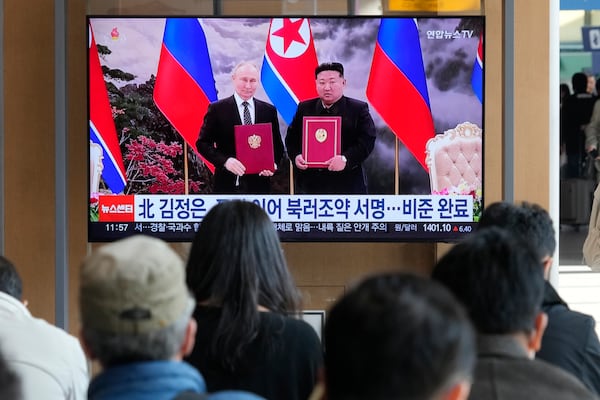 A TV screen shows a file image of North Korean leader Kim Jong Un, right, and Russian President Vladimir Putin in Pyongyang, during a news program at the Seoul Railway Station in Seoul, South Korea, Tuesday, Nov. 12, 2024. (AP Photo/Ahn Young-joon)