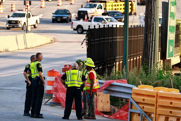 Dunwoody police talk to Georgia Department of Transportation workers on the scene at Ashford Dunwoody Road and I-285.