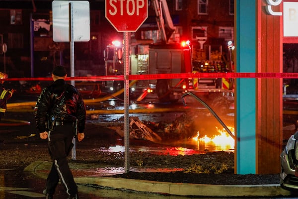 FILE - Fuel burns in the street at Bustleton and Cotton Ave. after a small plane crashed near Roosevelt Mall, Friday, Jan. 31, 2025, in Philadelphia. (Steven M. Falk/The Philadelphia Inquirer via AP, File)