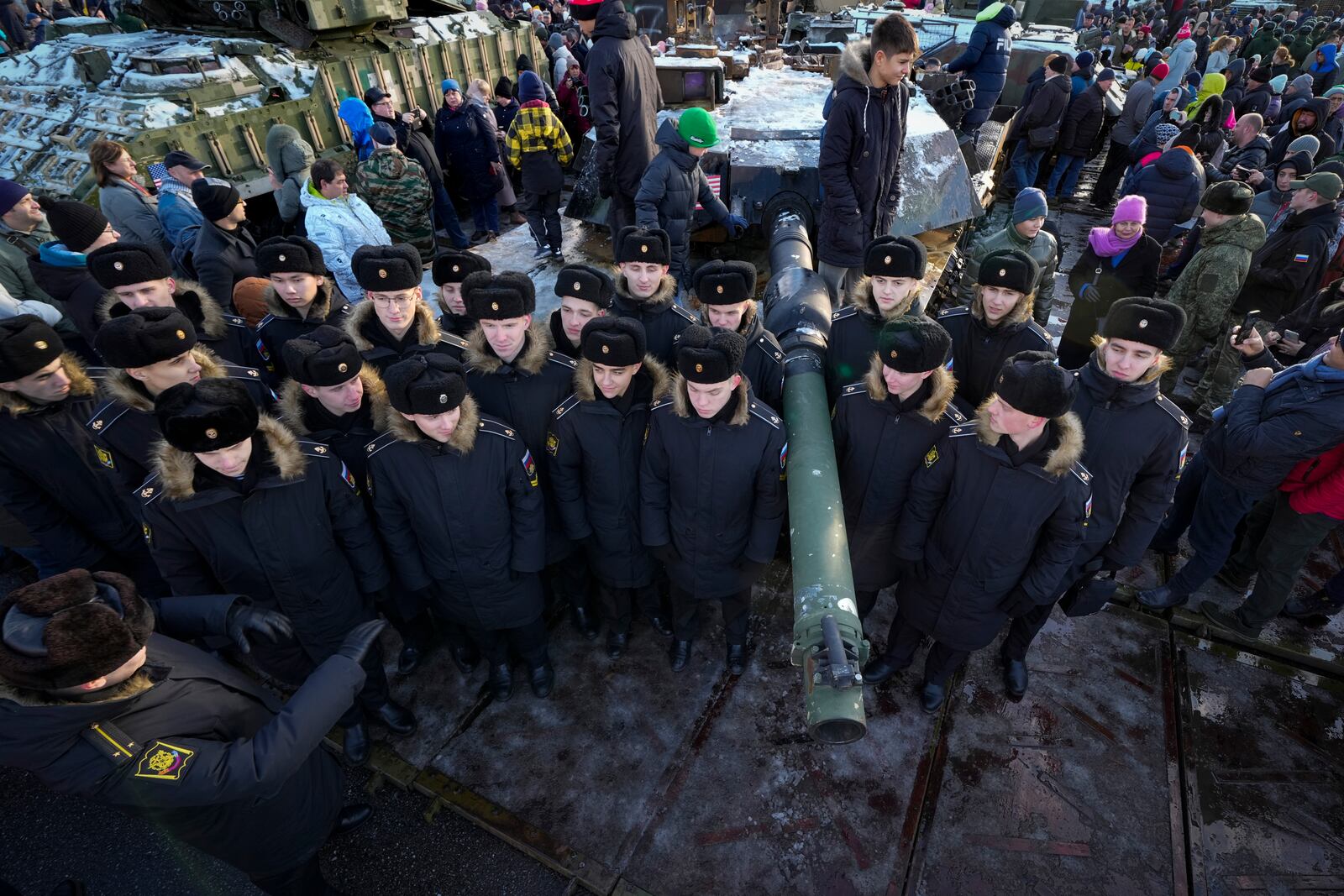 Navy cadets stand next to an Ukrainian U.S.-made M1 Abrams tank at an exhibition featuring military equipment captured from Kyiv forces during the fighting in Ukraine, during Russia's National Unity Day in St. Petersburg, Russia, Monday, Nov. 4, 2024. (AP Photo/Dmitri Lovetsky)