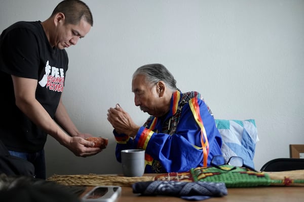 Leonard Peltier, right, participates in a prayer with members of the NDN Collective in Belcourt, N.D, on Tuesday, Feb. 25, 2025. (AP Photo/Mark Vancleave)