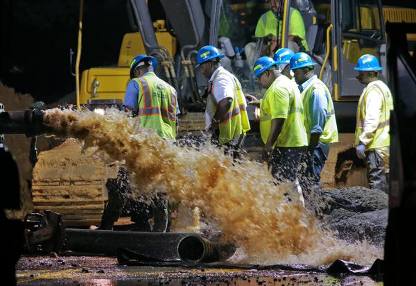 LEDE PHOTO - Sept. 5, 2013 Brookhaven: DeKalb County Watershed Management crews continued Thursday to repair a ruptured water main that shut down a heavily-traveled Brookhaven road and left several hundred residents and businesses without water. Clairmont Road remained closed Thursday between I-85 and Century Center, a stretch of road that runs northwest of the interstate. Just before 6 a.m, a new section of 30-inch pipe arrived at the site to replace the broken pipe. Authorities have not said when they expected to have the road reopened. The break. which happened around noon Wednesday, hasn't required a boil alert, DeKalb Couunty spokesman Burke Brennan said. Brennan said Thursday that 200 to 300 customers, including a nearby Holiday Inn Express hotel, were without water. JOHN SPINK/JSPINK@AJC.COM This photo, from September 2013, ran with Sunday's story. JOHN SPINK/JSPINK@AJC.COM