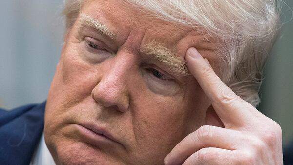 President Donald Trump attends a meeting on healthcare with opponents of the Affordable Care Act in the Roosevelt Room of the White House on March 13, 2017 in Washington, DC. A federal judge late Wednesday blocked Trump’s new travel ban.