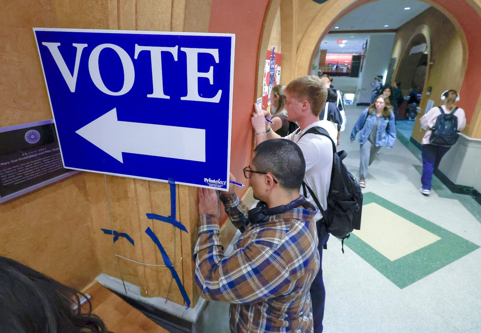 Students at The University of Wisconsin-Madison fill out ballots during the first day of Wisconsin's in-person absentee voting on the campus in Madison, Wisc., Tuesday, Oct. 22, 2024. (AP Photo/John Hart, Wisconsin State Journal)